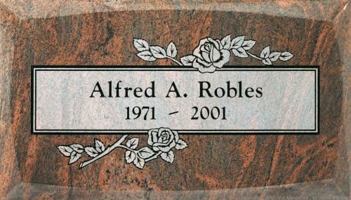 Single flat granite headstone in red multicolor granite for Alfred A. Robles, with engraved roses above and below the nameplate