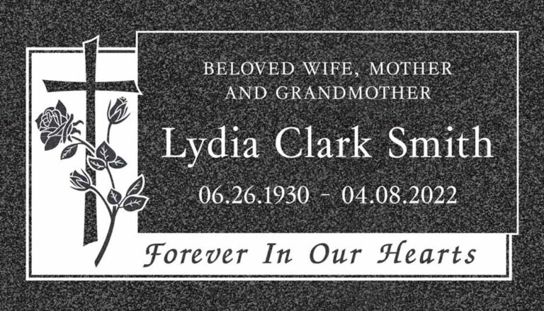 Granite grave marker with cross, roses, and rounded panel