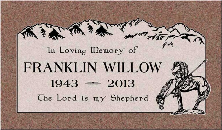 Granite grave marker with horseback rider, mountain range, and eagles