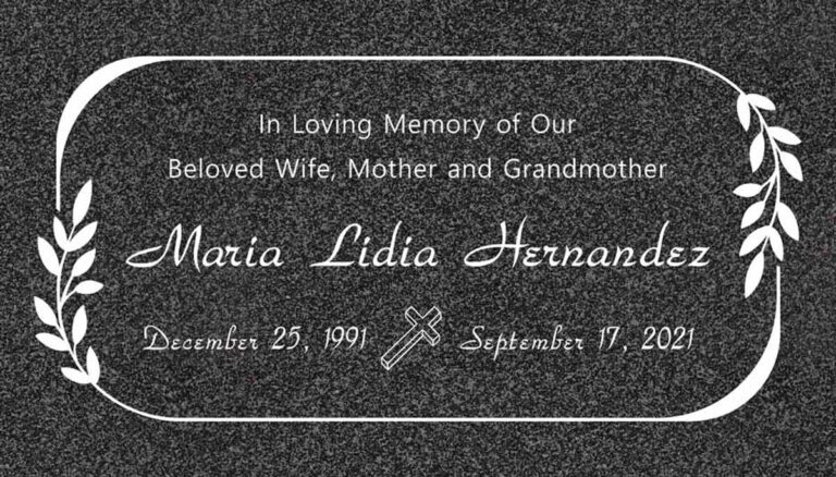 Granite grave marker with rounded border and olive branch accents
