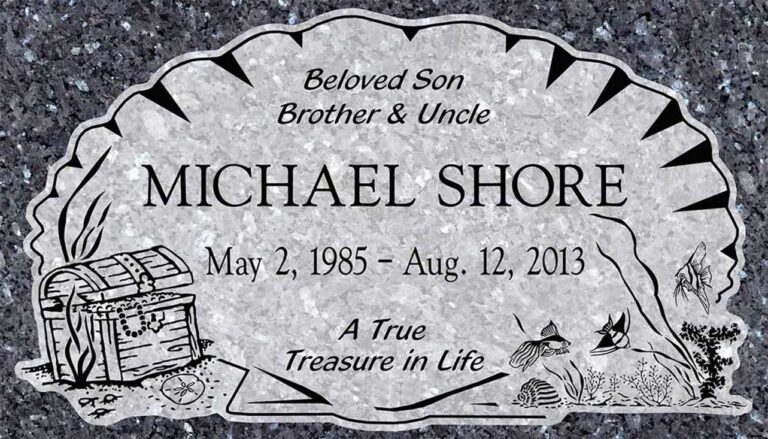 Granite grave marker in seashell shape with treasure chest and tropical fish
