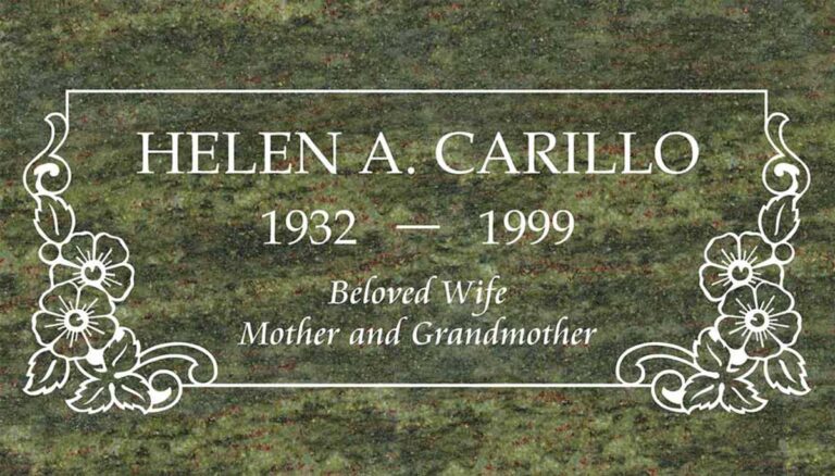 Granite gravestone with flowers, scrollwork accents, and elegant border