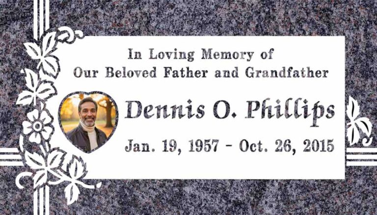 Granite gravestone with heart portrait area, flowers, vine, and cross