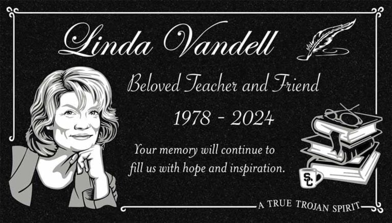 Granite gravestone with portrait, quill pen, and stacked books for an educator