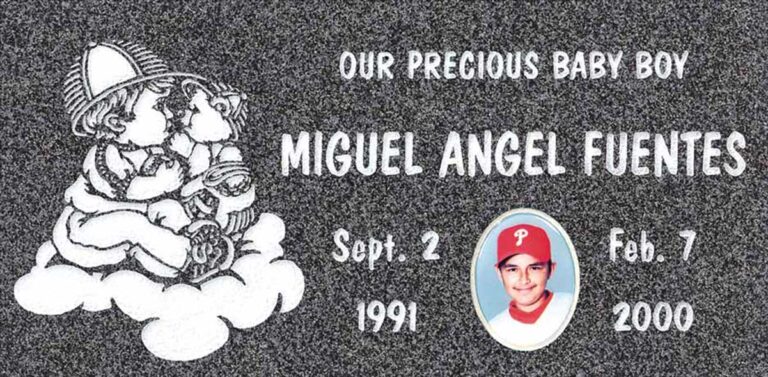 Granite gravestone with teddy bear on cloud and oval portrait cameo