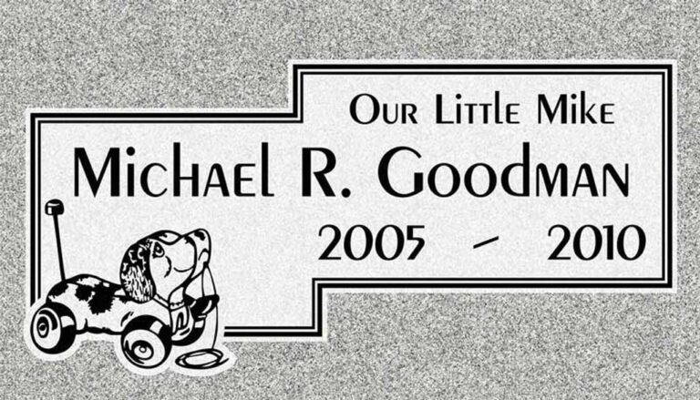 Granite gravestone with toy pull wagon and puppy dog