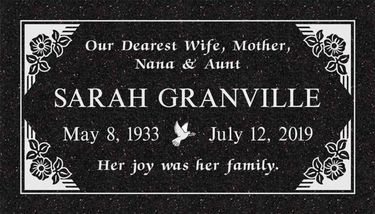 Granite headstone with art deco corner accents and flower details on frosted panel