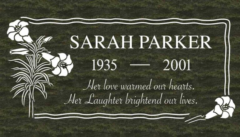 Granite headstone with lily flowers and wave-style multi-line border