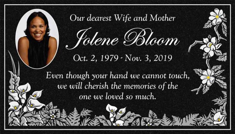 Granite headstone with portrait, calla lilies, plumeria, and ferns