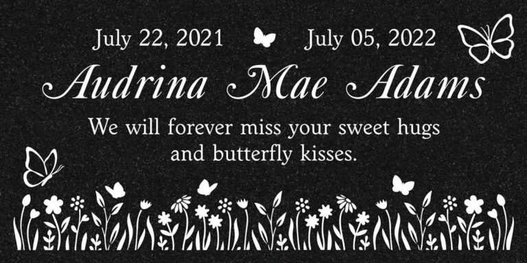 Granite memorial with butterflies and wildflower garden silhouette