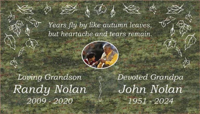 Granite companion memorial with falling autumn leaves and oval portrait