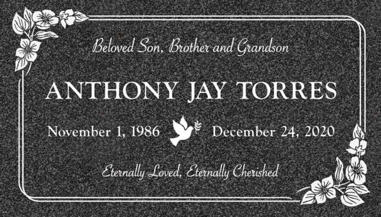 Granite memorial with dove, hibiscus flowers, and rounded border