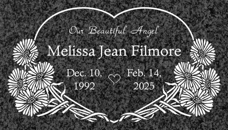 Granite memorial with heart outline and daisy flowers