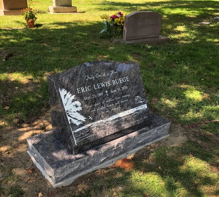 Granite slant memorial with palm tree and beach scene etching at Oak Park Cemetery in Claremont