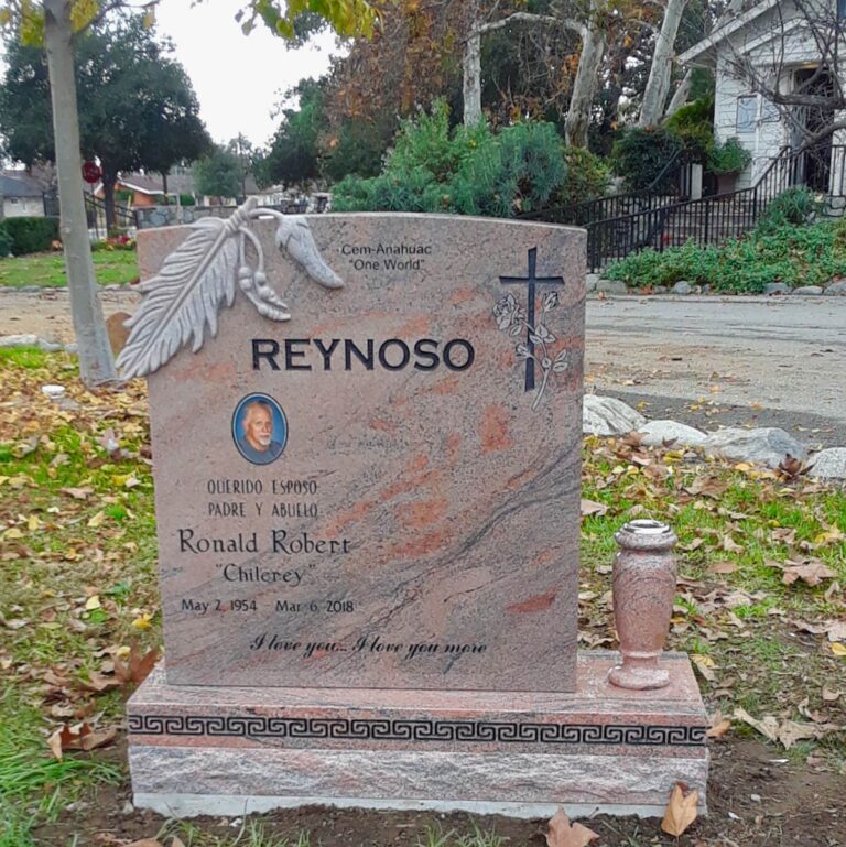 Granite monument with carved feather accent and greek key border on base at Oak Park Cemetery in Claremont