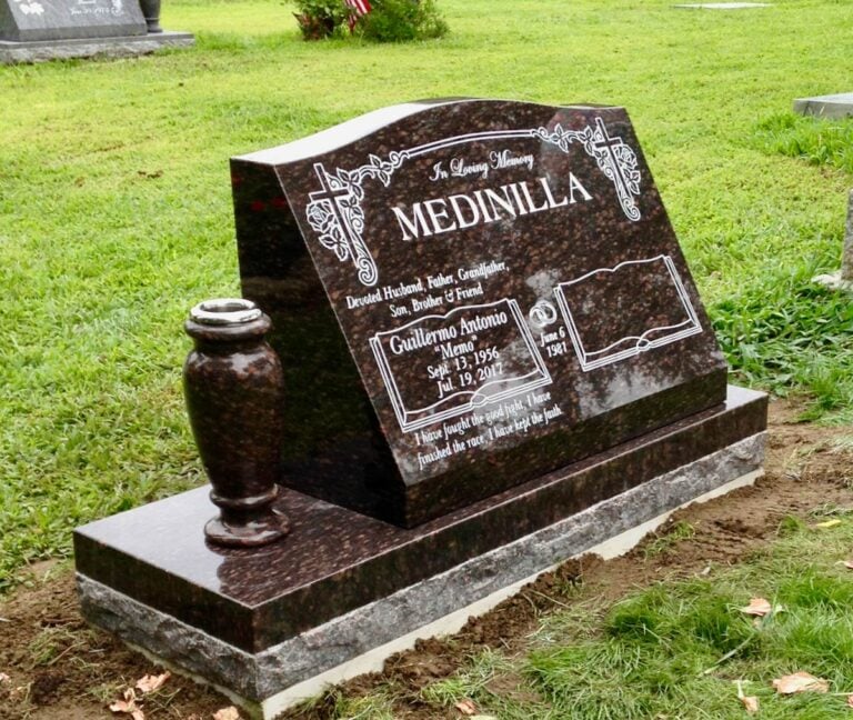 Granite slant memorial with cross and scrollwork and open book etching at Oak Park Cemetery in Claremont