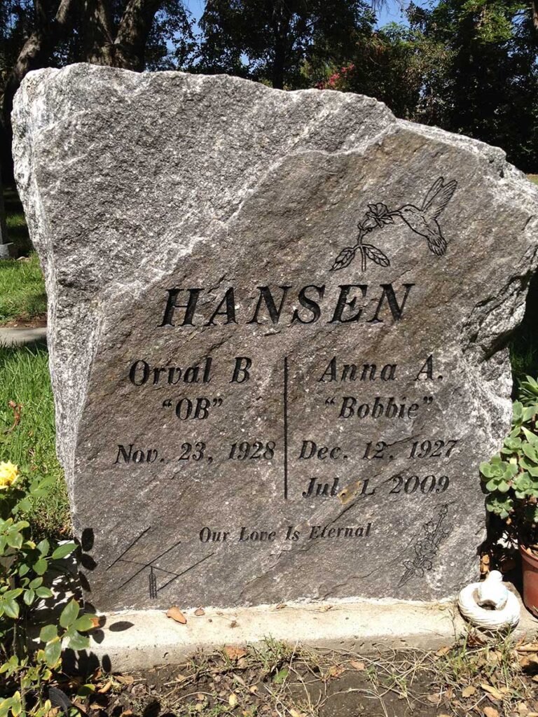 Companion granite monument in rustic boulder shape with bird etching at Oak Park Cemetery in Claremont