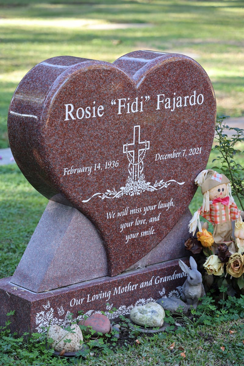 Heart shaped Sentinel Red granite monument with cross design for Rosie Fajardo at Oak Park Cemetery