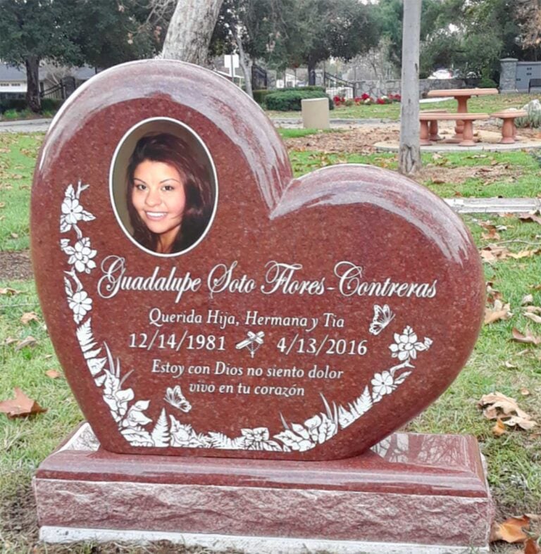 Upright heart-shaped granite monument with porcelain portrait and flower etchings at Oak Park Cemetery in Claremont
