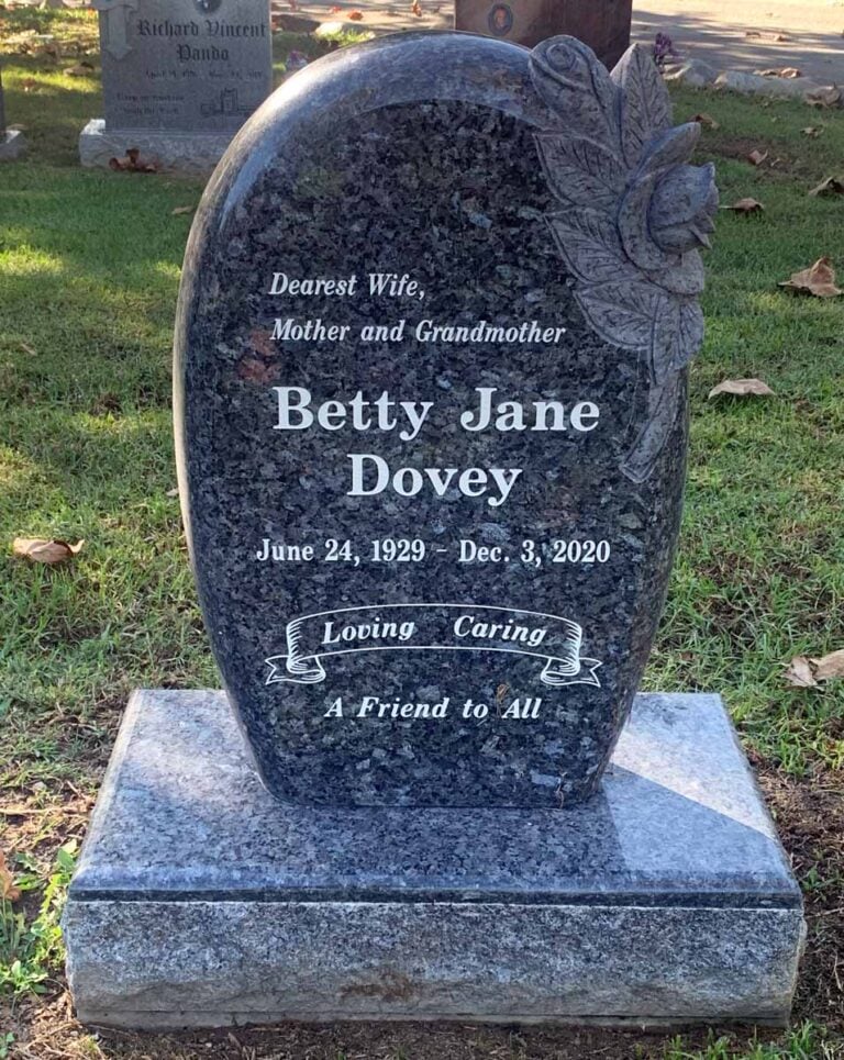 Granite monument with sculpted flower accent in blue pearl granite at Oak Park Cemetery in Claremont