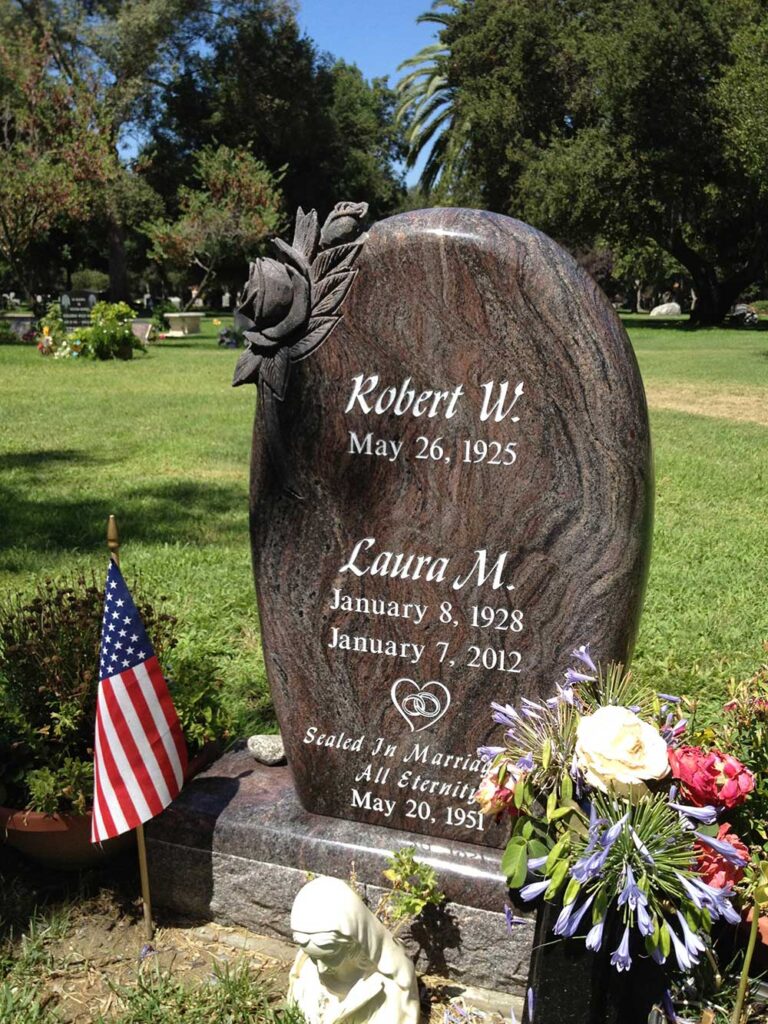 Granite monument with sculpted rose and oval shape at Oak Park Cemetery in Claremont