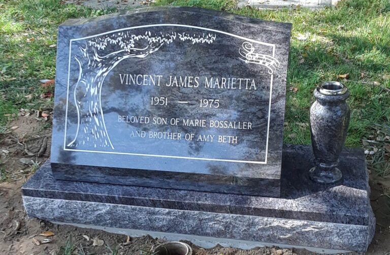 Granite monument with tree etching in decorative border and granite vase at Oak Park Cemetery in Claremont