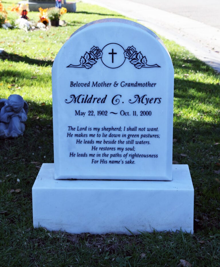 White marble monument with roses and cross and psalm inscription at Oak Park Cemetery in Claremont