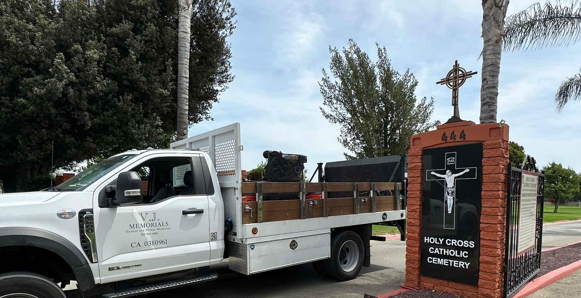 VJ Memorials delivery truck at the Holy Cross Catholic Cemetery entrance in Pomona