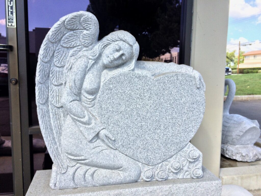 Southern White granite upright monument with angel holding heart