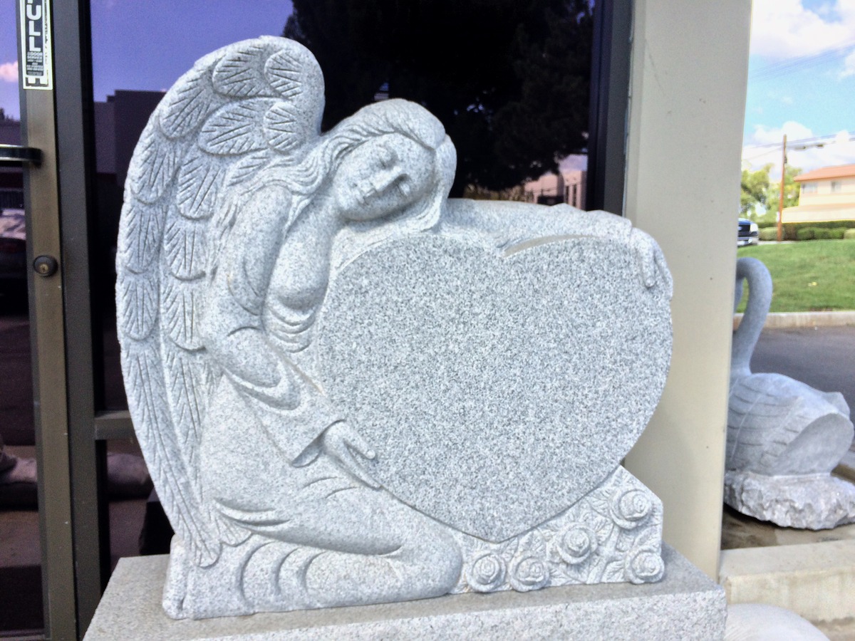 Southern White granite upright monument with angel holding heart