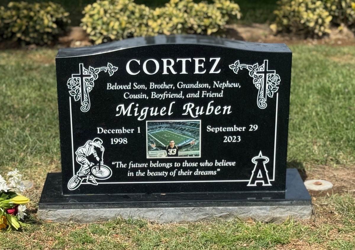 Black granite upright monument with bmx rider and crosses, Cortez family