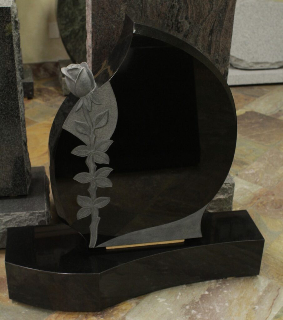 Black granite upright monument with crescent carved rosebud