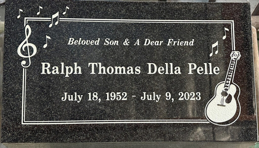 Oxford Gray granite grave marker with guitar and music notes, Della Pelle family, Oak Park Cemetery