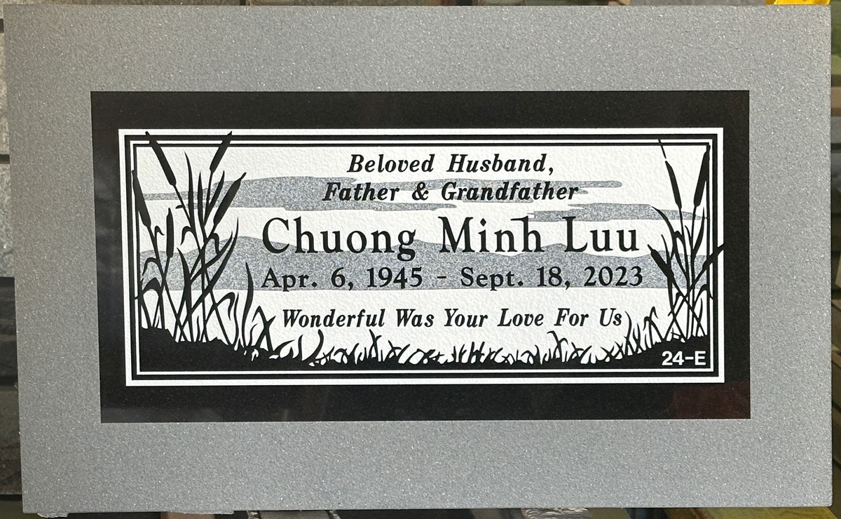 Black granite headstone with cattails and marsh, Luu family, Hillside Memorial Park