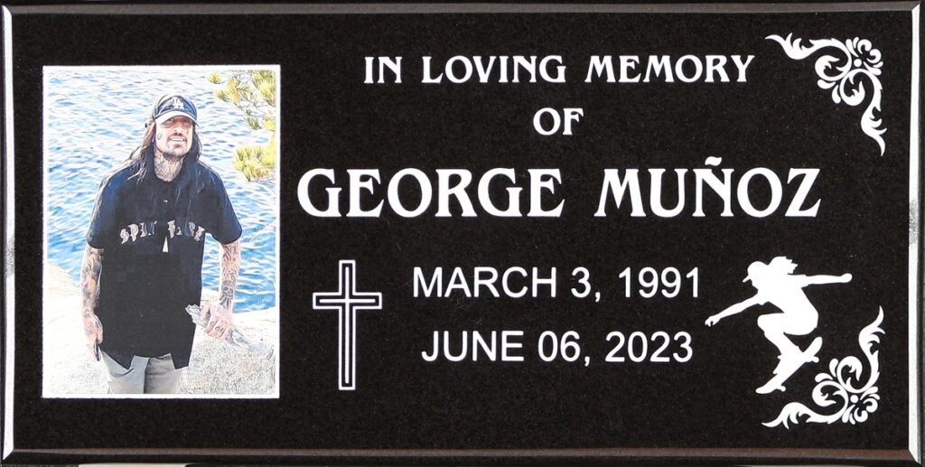 Black granite grave memorial with skateboarder, Munoz family, Holy Cross Cemetery
