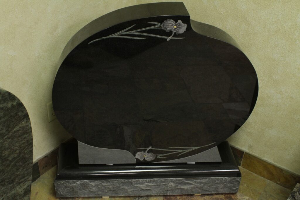 Black granite upright monument with oval etched irises