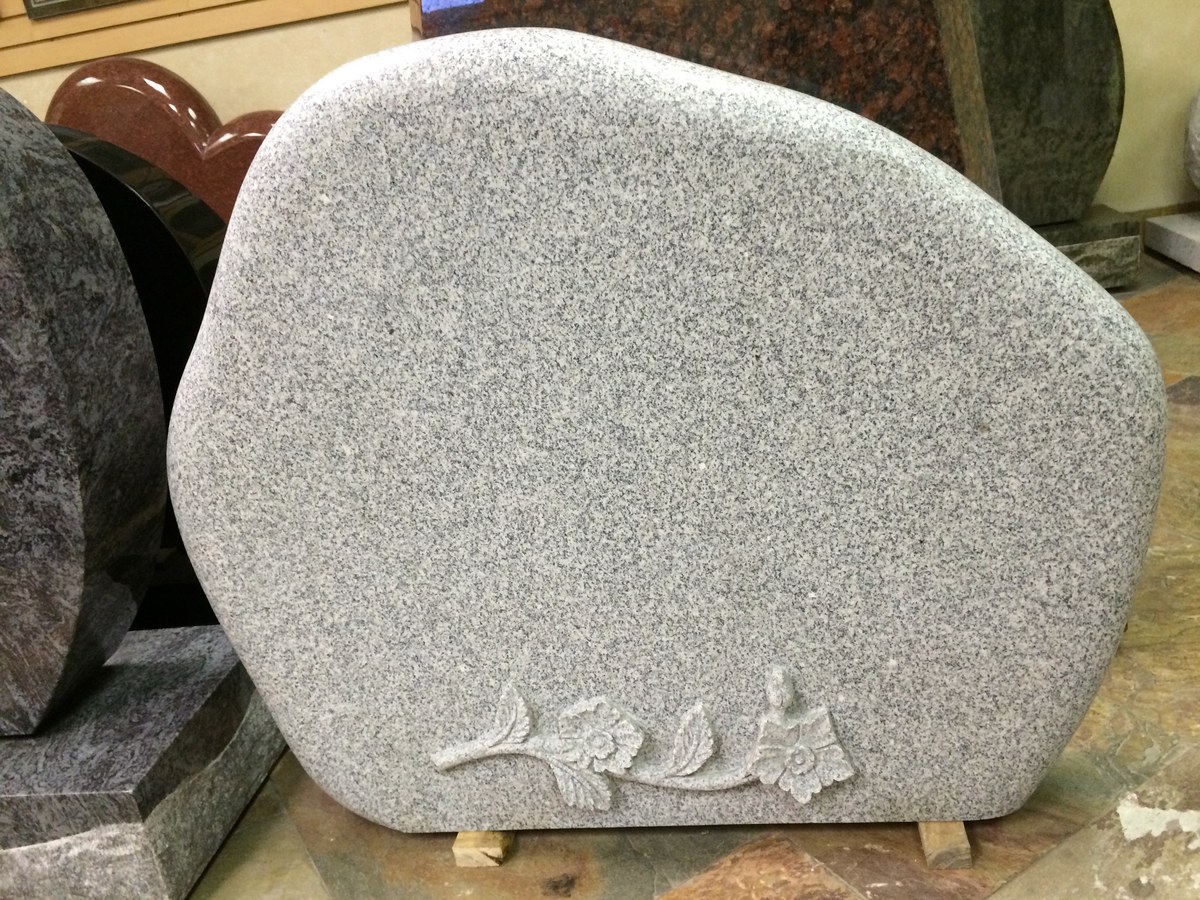 Southern White granite upright monument with rounded carved flower