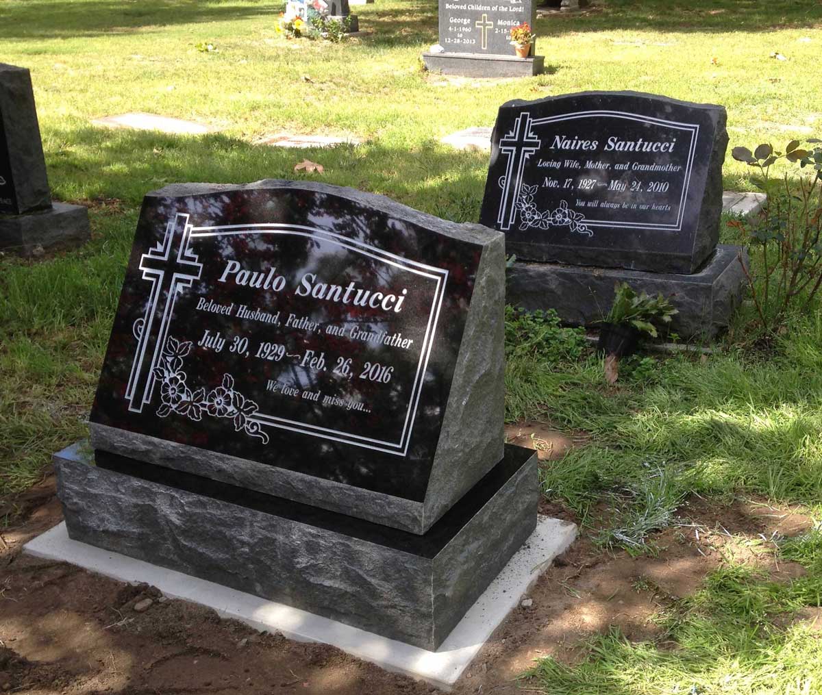 Black granite slant memorial with cross and flowers, Santucci family, Oak Park Cemetery