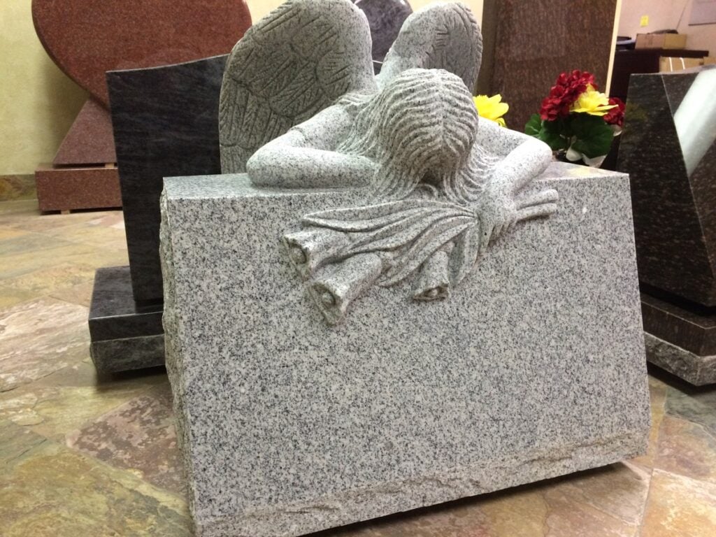Southern White granite slant memorial with sleeping angel roses
