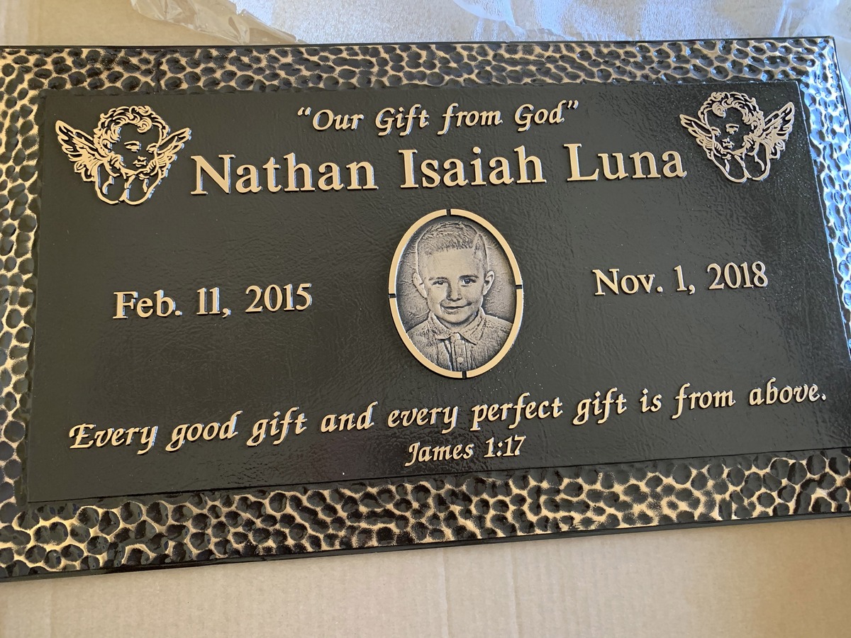 Bronze memorial marker with cherubs and portrait, Luna family, Forest Lawn Memorial Park