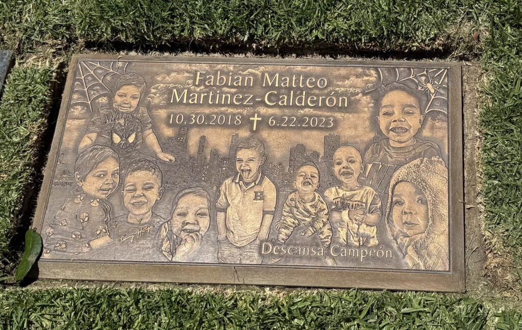Bronze headstone with portraits and city skyline, Martinez-Calderon family, All Souls Catholic Cemetery